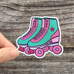 1980s vintage retro roller skates with pink wheels, teal shoe, and pink stars.