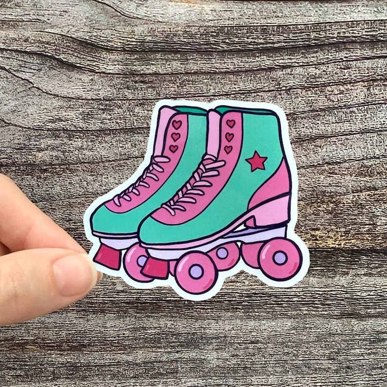 1980s vintage retro roller skates with pink wheels, teal shoe, and pink stars.