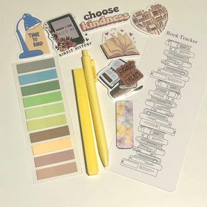 May include: A selection of stationery items for book lovers. Includes stickers with text such as "Time to Read" and "Choose Kindness", a bookmark, sticky notes, and yellow pens. The stickers feature book and reading-related designs.