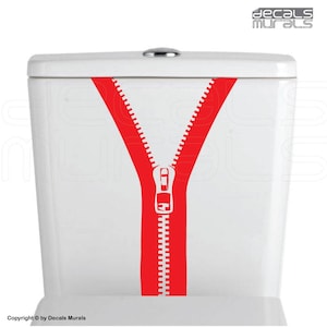 May include: A red zipper decal on a white toilet tank. The zipper is open and the teeth are visible. The decal is a fun and quirky way to add personality to a bathroom.
