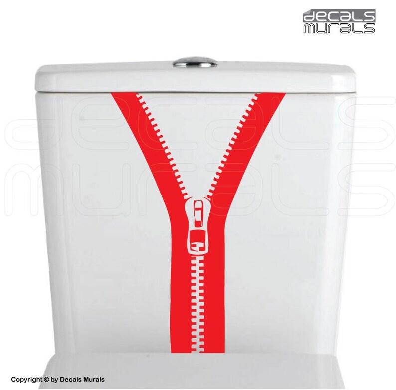 May include: A red zipper decal on a white toilet tank. The zipper is open and the teeth are visible. The decal is a fun and quirky way to add personality to a bathroom.