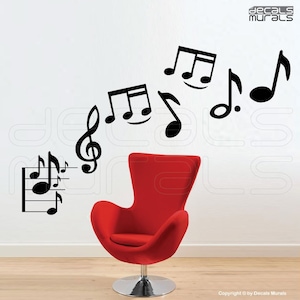 May include: Black music note wall decals on a white wall with a red chair in the foreground. The decals include a treble clef, a staff with notes, and several individual notes.