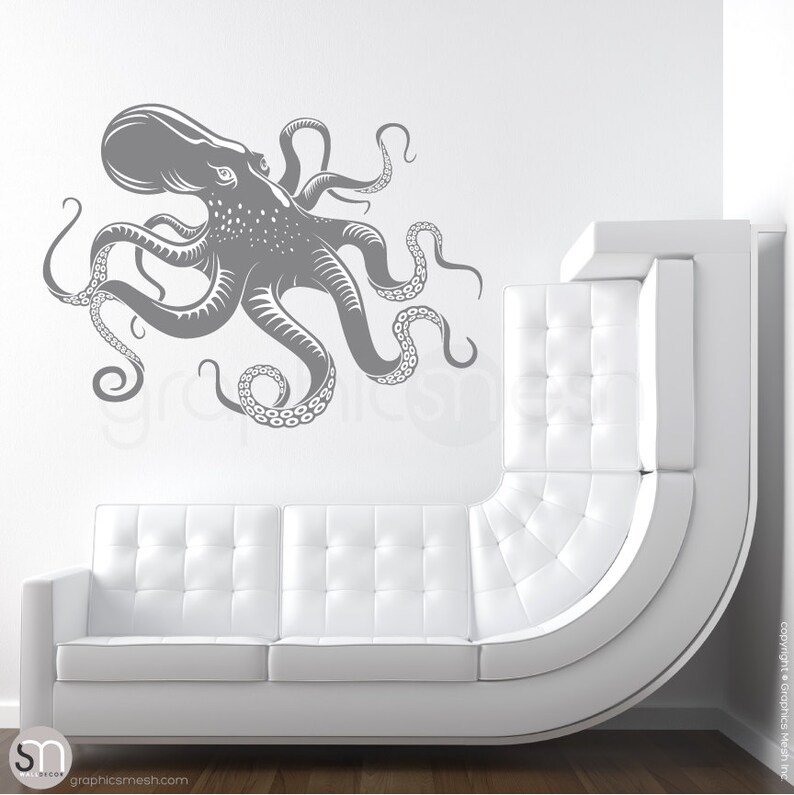 May include: A gray octopus wall decal with eight tentacles. The octopus is facing left and has a detailed design. The decal is shown on a white wall above a white couch.