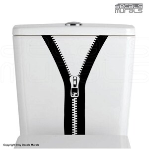 May include: A black and white zipper decal for a toilet tank. The zipper is open and the teeth are visible.