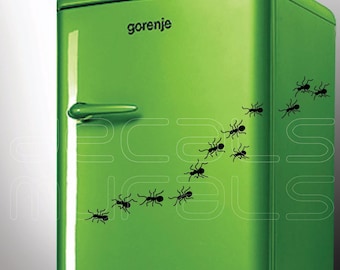 May include: A green refrigerator with the word "gorenje" on the front. A line of black ants is crawling up the side of the refrigerator.