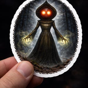 May include: A round sticker featuring a dark figure with glowing orange eyes and hands emitting yellow energy. The figure is wearing a long, dark robe and a hooded cowl. The background depicts a forest scene with bare trees.