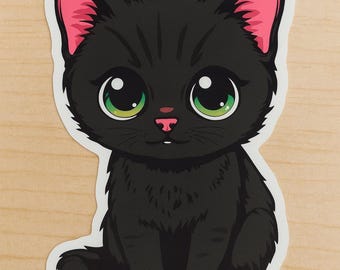 May include: A black cat sticker with large green eyes, pink inner ears, and a pink nose. The cat is sitting upright with its paws in front. The sticker has a white border and is on a light wood grain background.