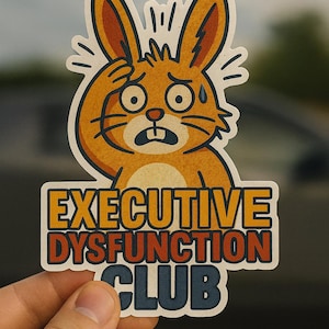 May include: A sticker depicting a worried cartoon rabbit in orange and brown, touching its head. The sticker has the text "EXECUTIVE DYSFUNCTION CLUB" in orange, red, and blue lettering.