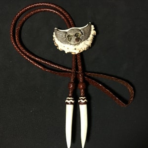 Bolo tie with a steampunk theme on an elk antler burr with deer antler tips