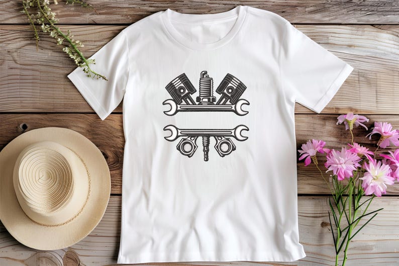 May include: White t-shirt with a black graphic of engine parts, including pistons, a spark plug, and wrenches. The design is centered on the shirt, suitable for mechanics or automotive enthusiasts.