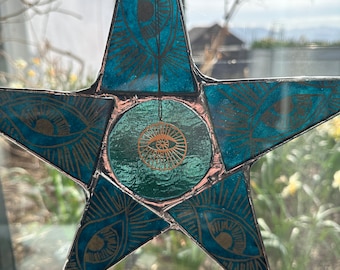All Seeing Star- 11 inch lacquered paper under glass points with art glass center and brass eye medallion