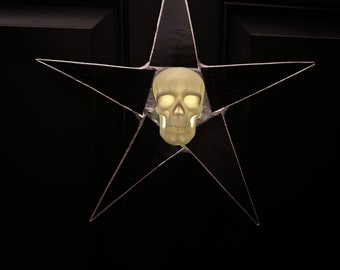 Illuminating Skull Star- 13 inch glossy black art glass ornament with porcelain skull that lights up, battery operated