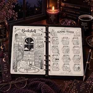 May include: An open ring-bound planner featuring a black and white illustration of a cosy library bookshelf on the left page and a monthly reading tracker with twelve jar-shaped graphics labelled by month on the right page, set in a dark room.