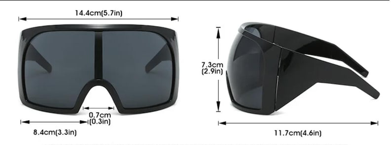 Op de afbeelding: Zwarte oversized zonnebril met een rechthoekig montuur. De zonnebril is 14,4 cm breed, 7,3 cm hoog en 11,7 cm lang. De brugbreedte is 0,7 cm. De glazen zijn donker en het montuur is effen zwart.