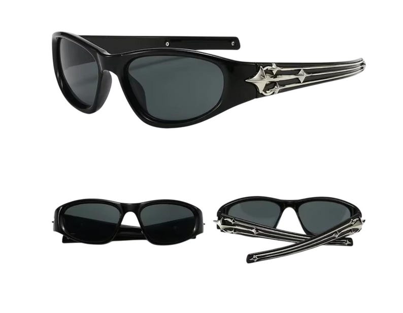 May include: Black sunglasses with a silver metal frame and a decorative design on the arms. The sunglasses have a dark lens and a curved shape.