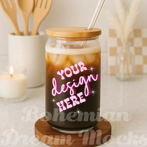 May include: A clear glass tumbler with a bamboo lid and a glass straw, filled with a dark beverage and ice. The words "YOUR design HERE" are displayed in pink. The tumbler sits on a wooden coaster.