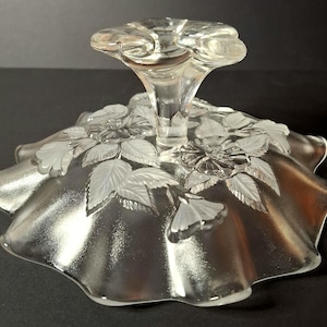 May include: A set of three ceramic mugs with a speckled, matte finish. The mugs are in shades of cream, light brown, and dark brown. Each mug has a simple, minimalist design and a rounded handle.