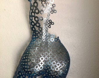 May include: A metal sculpture of a human torso made from hundreds of silver and blue metal washers. The sculpture is abstract and has a modern design.