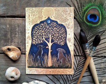 The Two Magicians Greetings Card by Hannah Willow Hare and Dog under a golden coloured Tree
