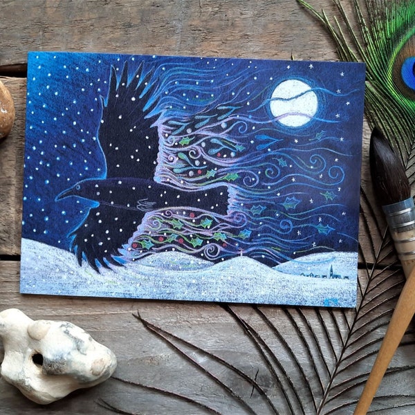 Yule Crow Greetings Card by Hannah Willow Crow flying through the Snow