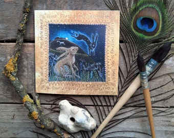 May include: A card with a whimsical illustration of a hare and a bird in a forest setting. The card features the text "The drum of the full moon dance, God foot coping, leaping to, On the silent field, flying to, Light, twisting to the smile."