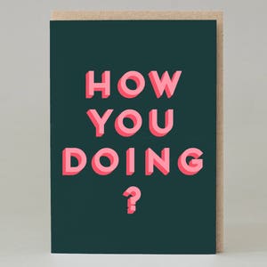 May include: Greeting card with the phrase "HOW YOU DOING?" in pink, 3D-style lettering on a dark teal background. The card has a natural kraft paper border.
