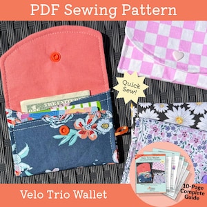 May include: A PDF sewing pattern for a Velo Trio Wallet featuring a dark blue floral fabric wallet with an orange snap, a pink and white checkered wallet with a heart snap, and a black and white daisy print wallet with a 10-page complete guide.