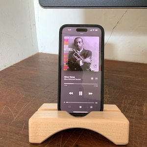 Maple iPhone stand acoustic amplifier playing music.