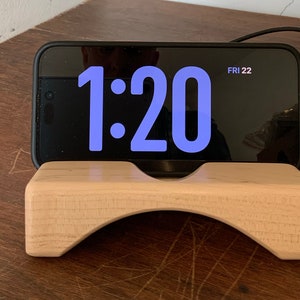 Wooden iPhone stand with iPhone in Standby.