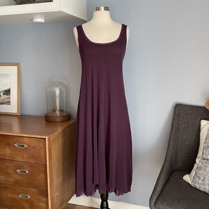 May include: A sleeveless, purple maxi dress with a scoop neck and a flowing, A-line silhouette.