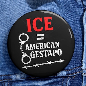 May include: A round, black button with the text "ICE = AMERICAN GESTAPO" in white and red. The button features a pair of handcuffs and barbed wire graphics.