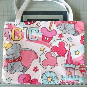 magic awaits tote bag