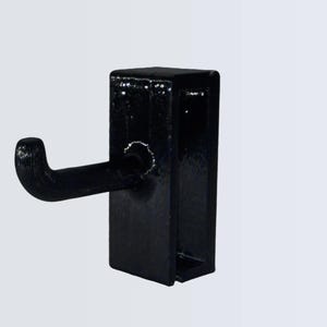 May include: A black metal hook with a rectangular base and a curved hook extending to the left. The hook is designed for hanging items. The finish appears to be glossy.