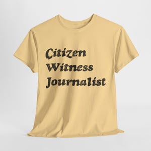 May include: A light yellow t-shirt with the text "Citizen Witness Journalist" printed in black.