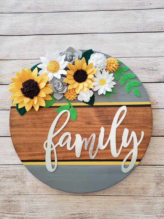 Round wood sunflower sign painted gray and stained steel "Family" decorated with all handmade felt sunflowers, flowers and leaves.