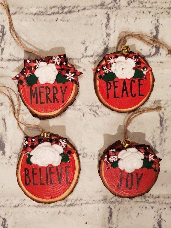 Set of 4 wood slice ornaments painted red with the words Peace, Joy, Merry and Believe in black handmade felt flower and buffalo check bow.