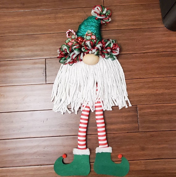 Elf gnome wreath w/ dangling legs. Mesh wreath with green hat and cotton beard and striped legs with green shoes wall decor hanging decor