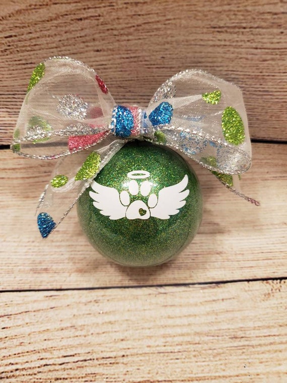 Green glittered 3 inch round pet memorial  ornament with name added for free with glittered polka dot bow and a white paw print with wings