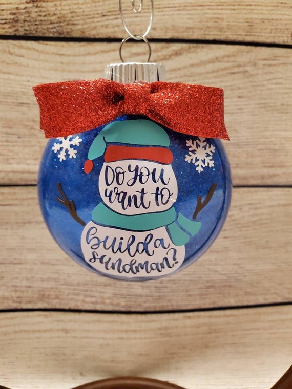 Glitter Ornament, blue disk with a red ribbon bow, Do you want to build a snowman?