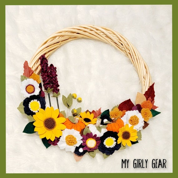 Felt flower fall wreath large in fall colors with pumpkins, sunflowers, and a huge mix of fall flowers decorating a grapevine wreath frame