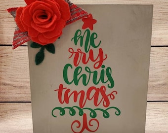 Grey painted wood sign with handmade felt flower and leaves with small plaid bow and Christmas tree word art in red and green.