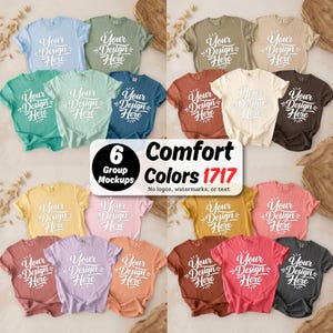 Pode incluir: Uma coleção de vinte e quatro camisetas de manga curta em várias cores sólidas, cada uma com o texto branco Your Design Here. Uma etiqueta central exibe o texto 6 Comfort Colors 1717 No logos, watermarks, or text.