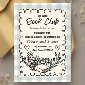 May include: A black and white invitation to a book club meeting. The invitation features a book, flowers, and hearts. The text reads "Join us for Book Club, Saturday, April 12th at 7pm. This month's read: Great Big Beautiful Life by Emily Henry. Bring a snack to share. 143 Willowbend Lane, Maple Grove, NY 11238."
