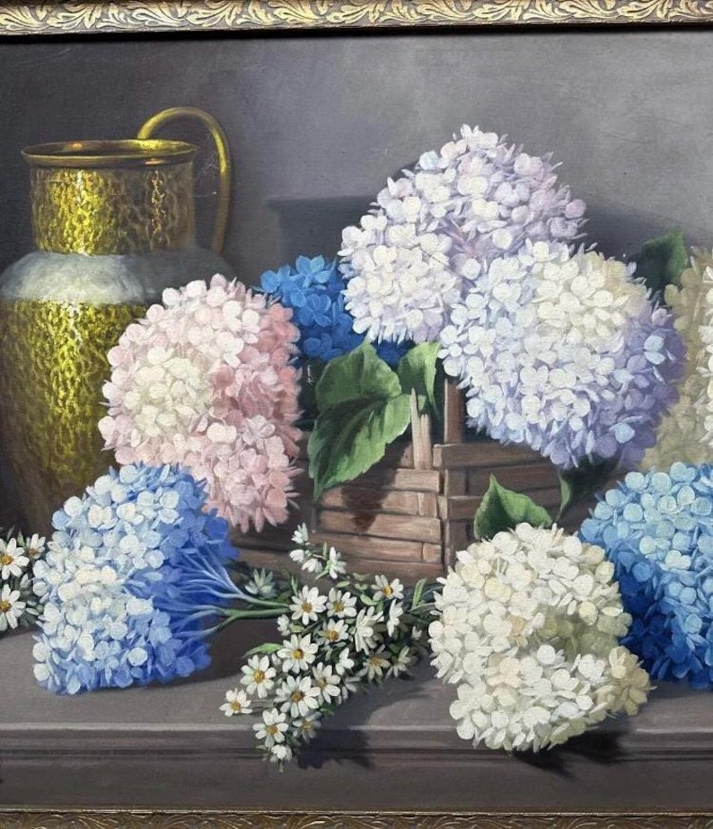 May include: A still life painting featuring a brass pitcher and a variety of hydrangeas in shades of blue, pink, and white. The flowers are arranged in a basket and on a table, with a few small white flowers scattered around the base.