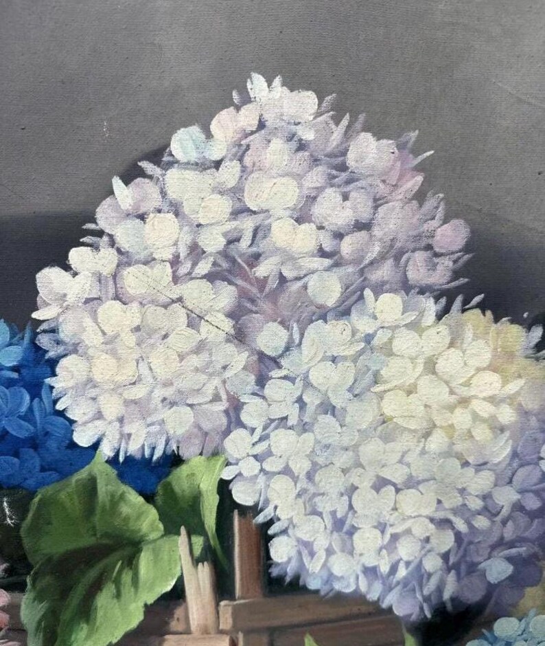 May include: A painting of a bouquet of hydrangeas in shades of blue, white, and purple. The flowers are arranged in a vase and are surrounded by green leaves.