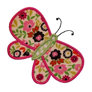 May include: A pink and green butterfly with floral fabric wings and black antennae. The butterfly is embroidered with a pink outline.