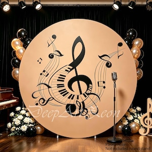 May include: A large circular backdrop featuring a black treble clef and piano keys graphic on a tan background. The design includes musical notes and staff lines. A silver microphone on a stand is positioned in front of the backdrop.