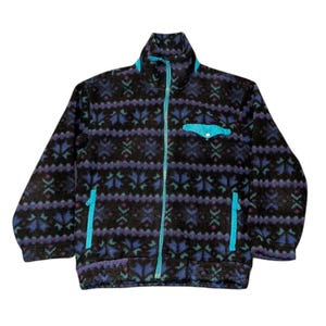 May include: A black fleece jacket with a colorful geometric pattern in blue, purple, and green. The jacket has a high collar, a full-length zipper, and two side pockets, all accented with bright turquoise. A small turquoise pocket is on the chest.