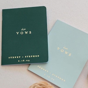 May include: Two rectangular vow booklets with gold foil lettering. The dark green booklet features the text his VOWS, SYDNEY + STEPHEN, and 2.16.24. The light sage green booklet features the text her VOWS, SYDNEY + STEPHEN, and 2.16.24.