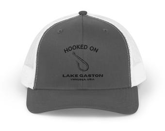 May include: A gray and white trucker hat with a black embroidered design that says "Hooked on Lake Gaston Virginia USA" with a fishing hook graphic.